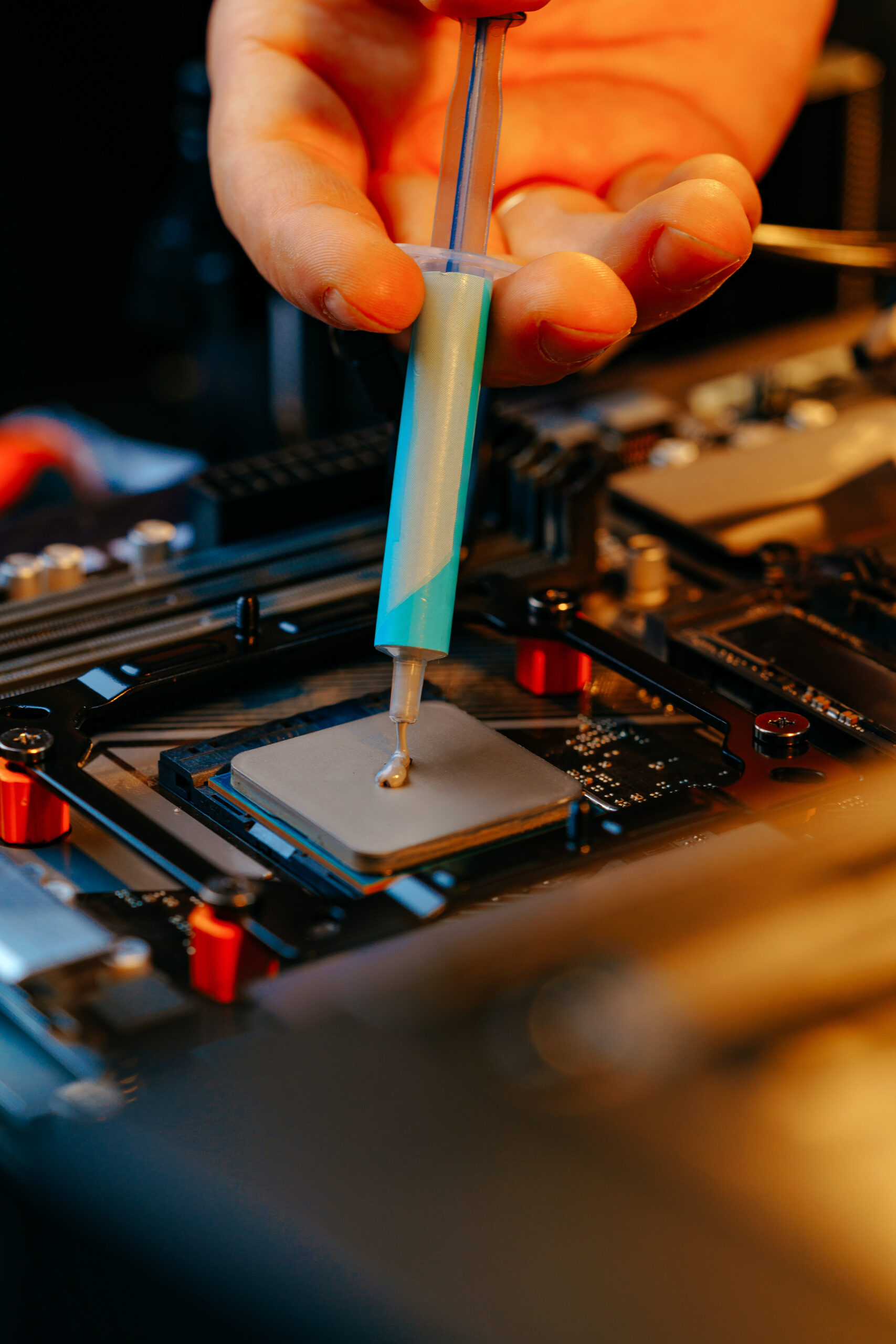 Applying thermal paste to a computer processor close up